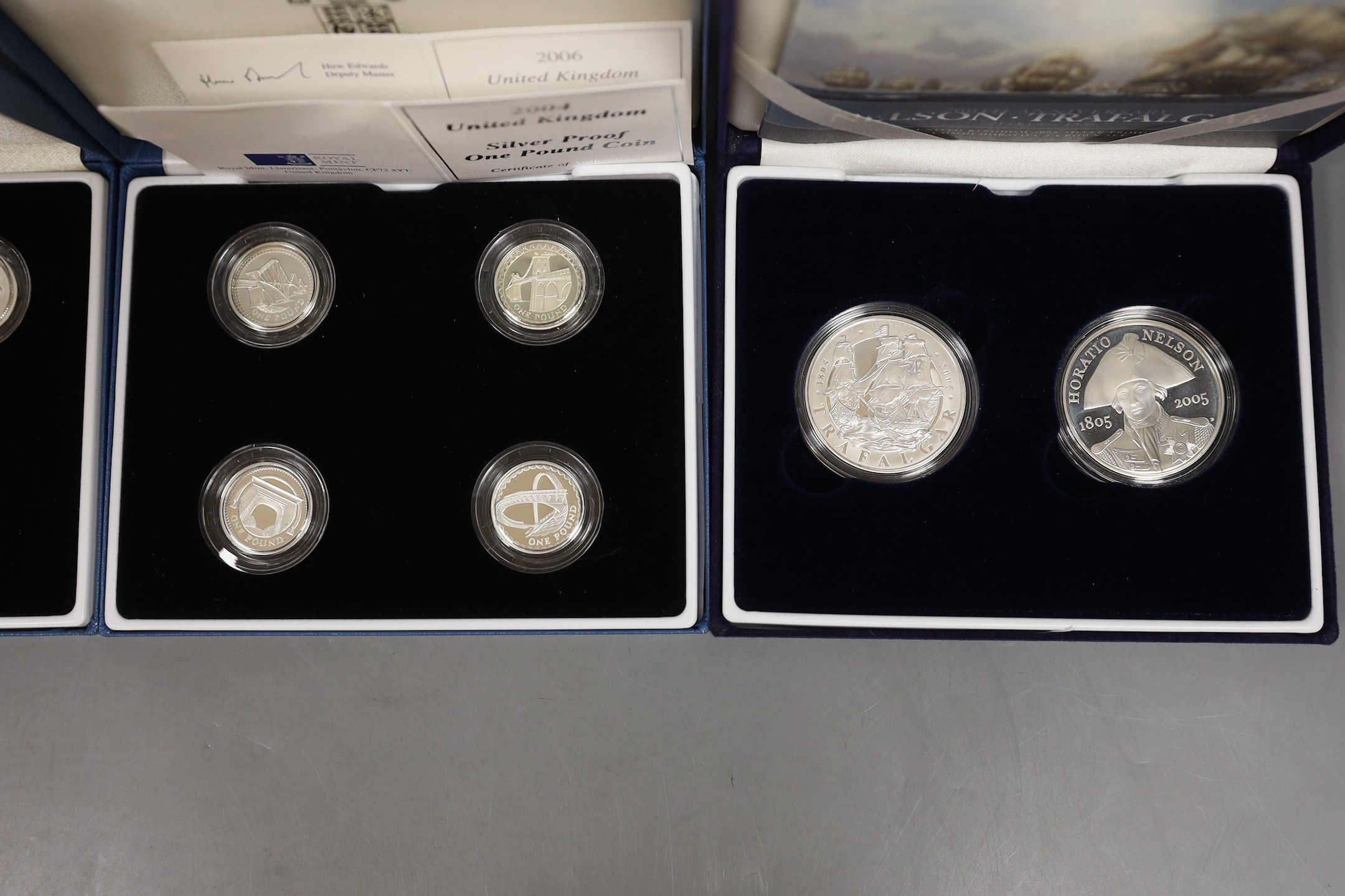 Three cased Royal Mint UK silver proof £1 coin collections 1984-87, 1994-96, 2004-07 and a 200th anniversary Nelson Trafalgar 2005 silver proof two crown set